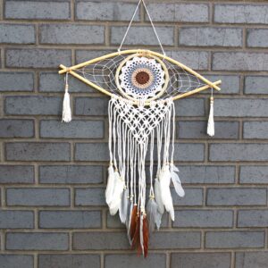 Handmade macrame dream catcher featuring an Evil Eye design in white, grey, and brown.