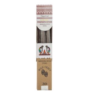 Golden frankincense smudging resin sticks with earthy texture in a natural setting.