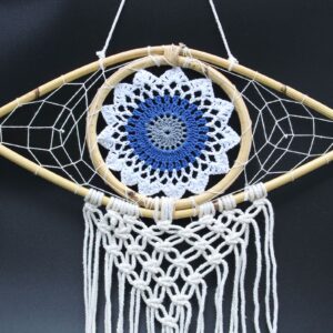 Handmade macrame dream catcher featuring an Evil Eye design in white, blue, and grey.