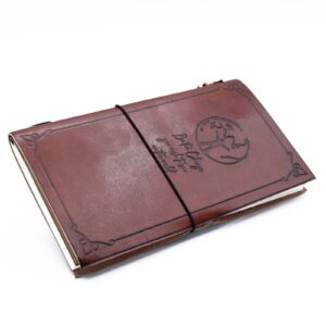 Brown handmade leather journal with embossed design and wrap-around band.