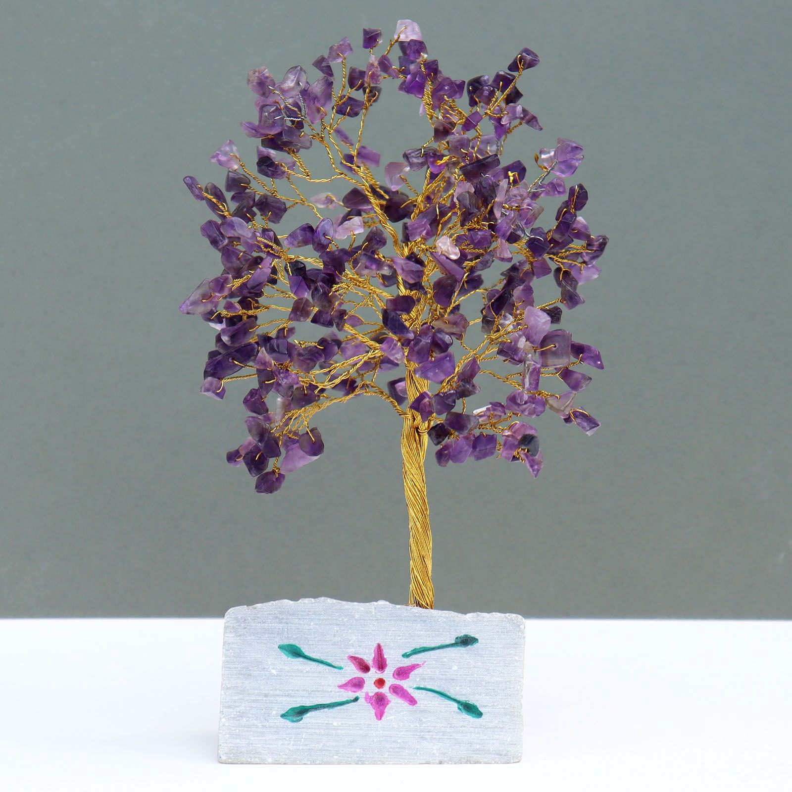 Handmade amethyst gemstone tree mounted on a rock base for home decor.