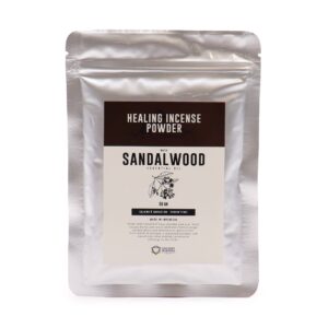 Sandalwood incense powder in a decorative holder with smoke rising.