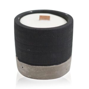 Black concrete pot candle with wooden wick and natural raw appearance.