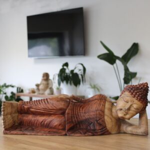 Hand-carved Suar wood Sleeping Buddha statue, showcasing intricate details.